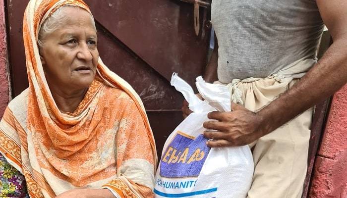 A flood victim receiving monthly rations